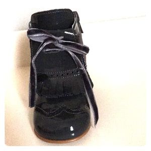Grey patent leather booties made in Spain